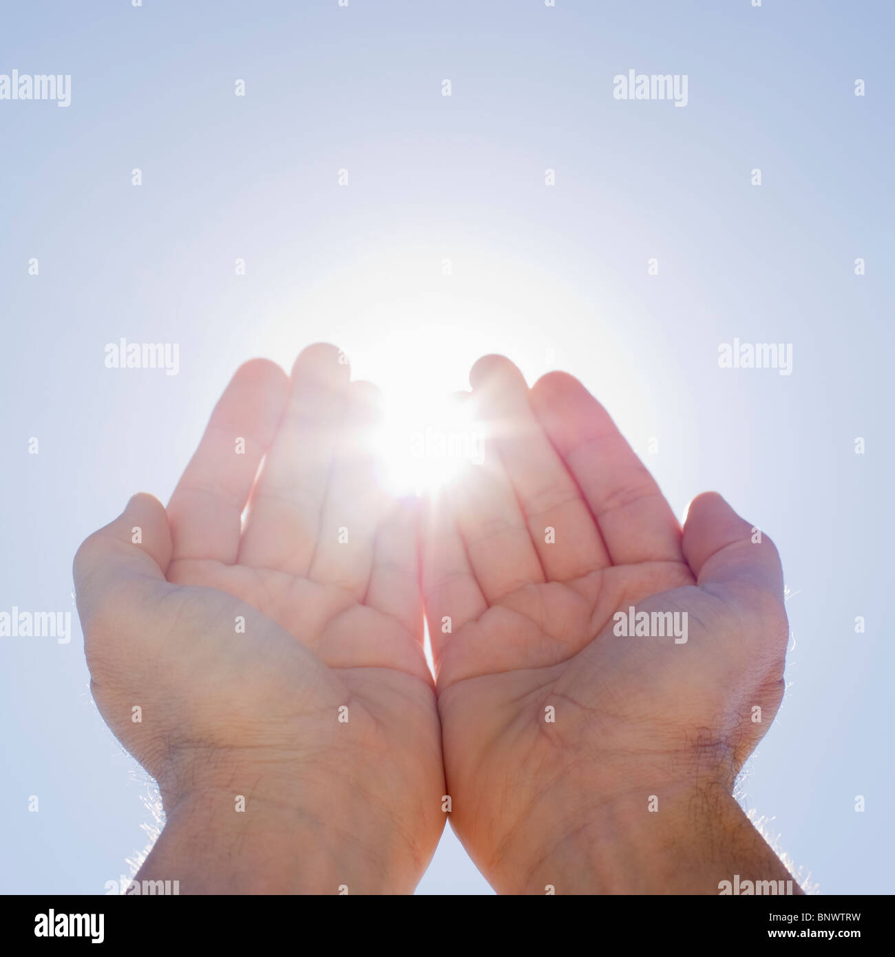 Hands framing sunshine Stock Photo