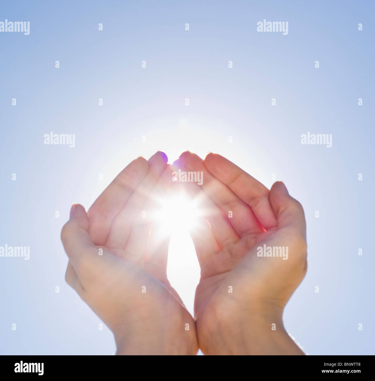 Hands framing sunshine Stock Photo