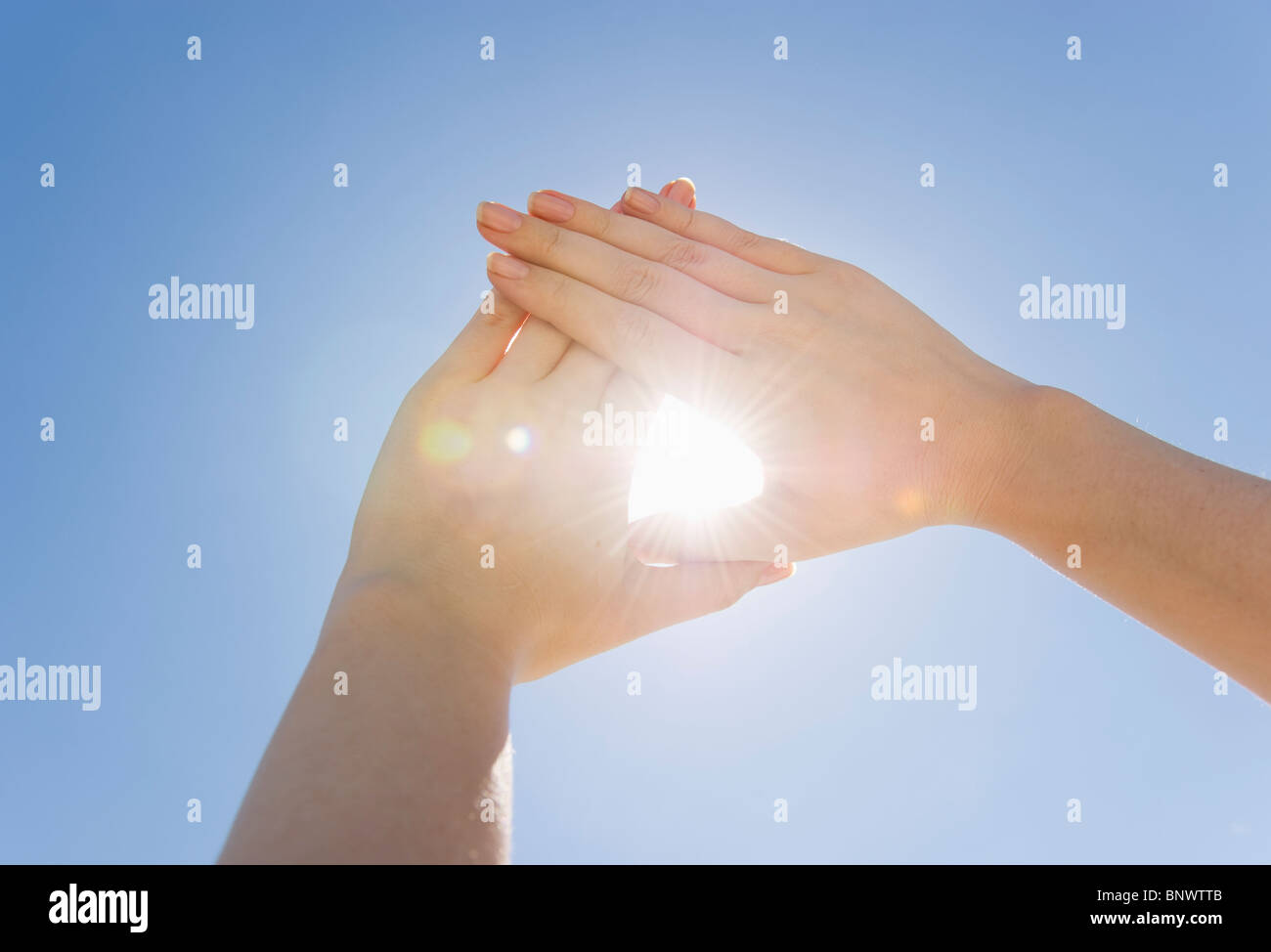 Hands framing sunshine Stock Photo