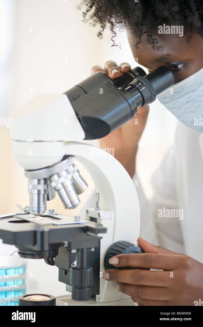 Black woman looking through microscope hires stock photography and images Alamy