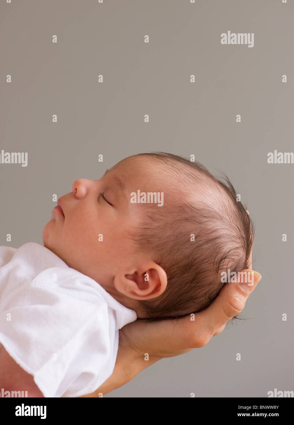 Baby sleeping in mother's hands Stock Photo Alamy