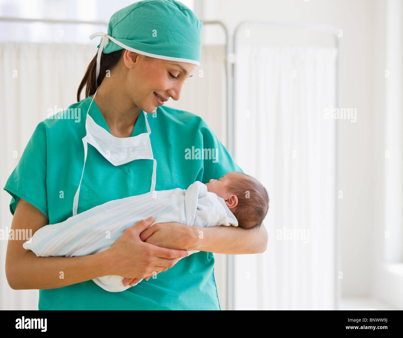 Nurse holding swaddled baby Stock Photo Alamy