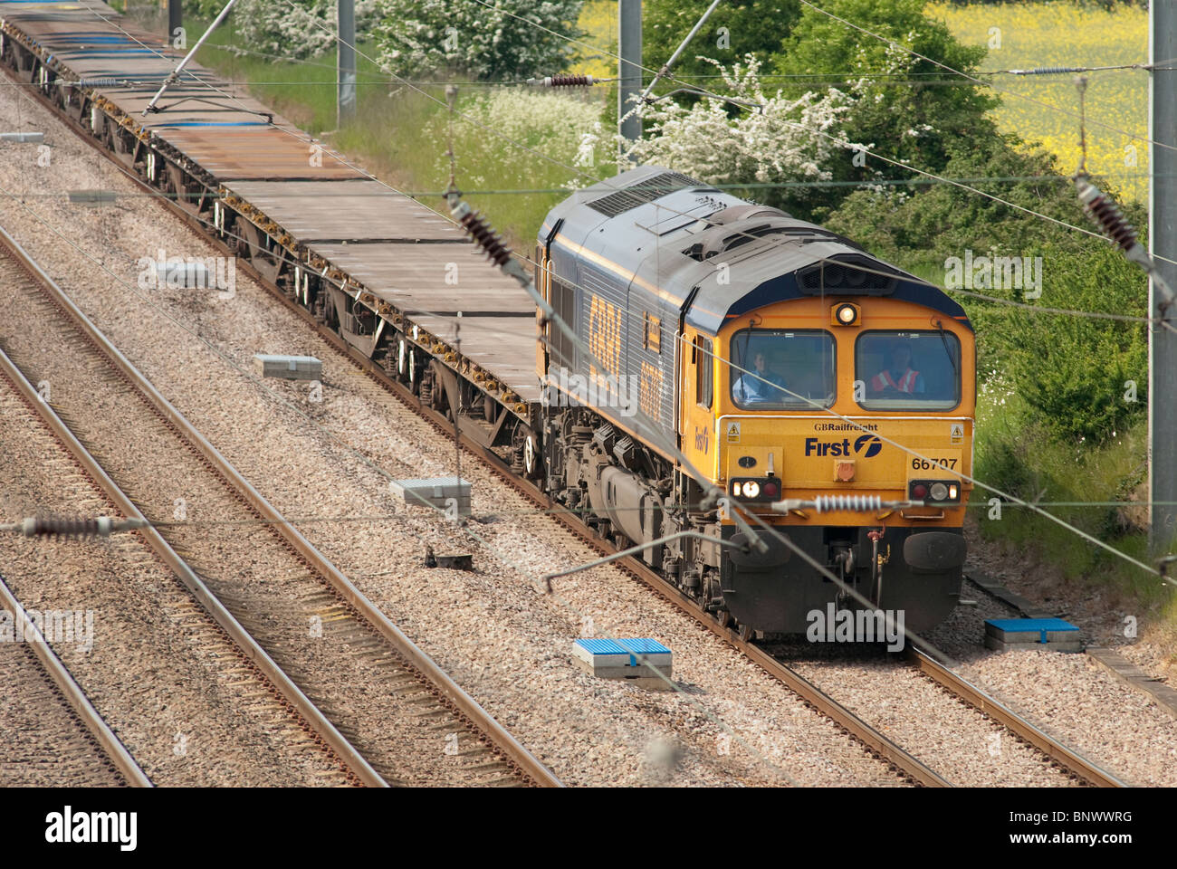 First GBRF class 66 locomotive hauling empty freight wagons on the english railway. Stock Photo