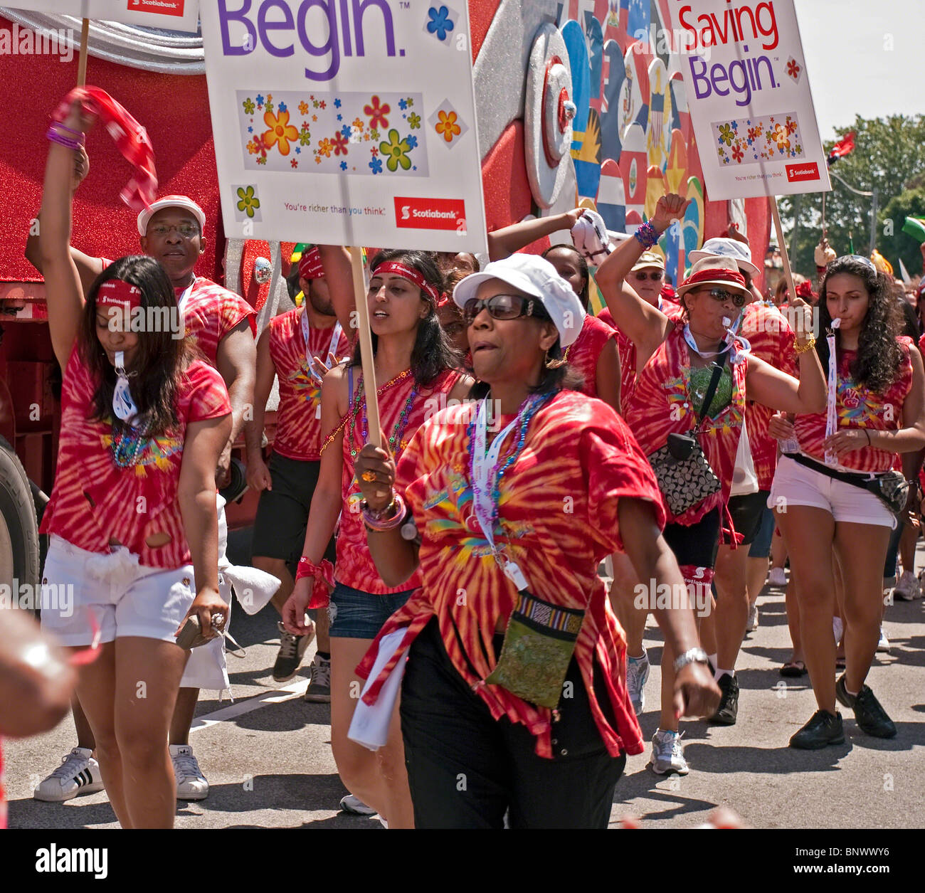 Toronto Caribana festival parade on July 31, 2010 - unidentified group of participants in colorful red outfits walk and dances. Stock Photo