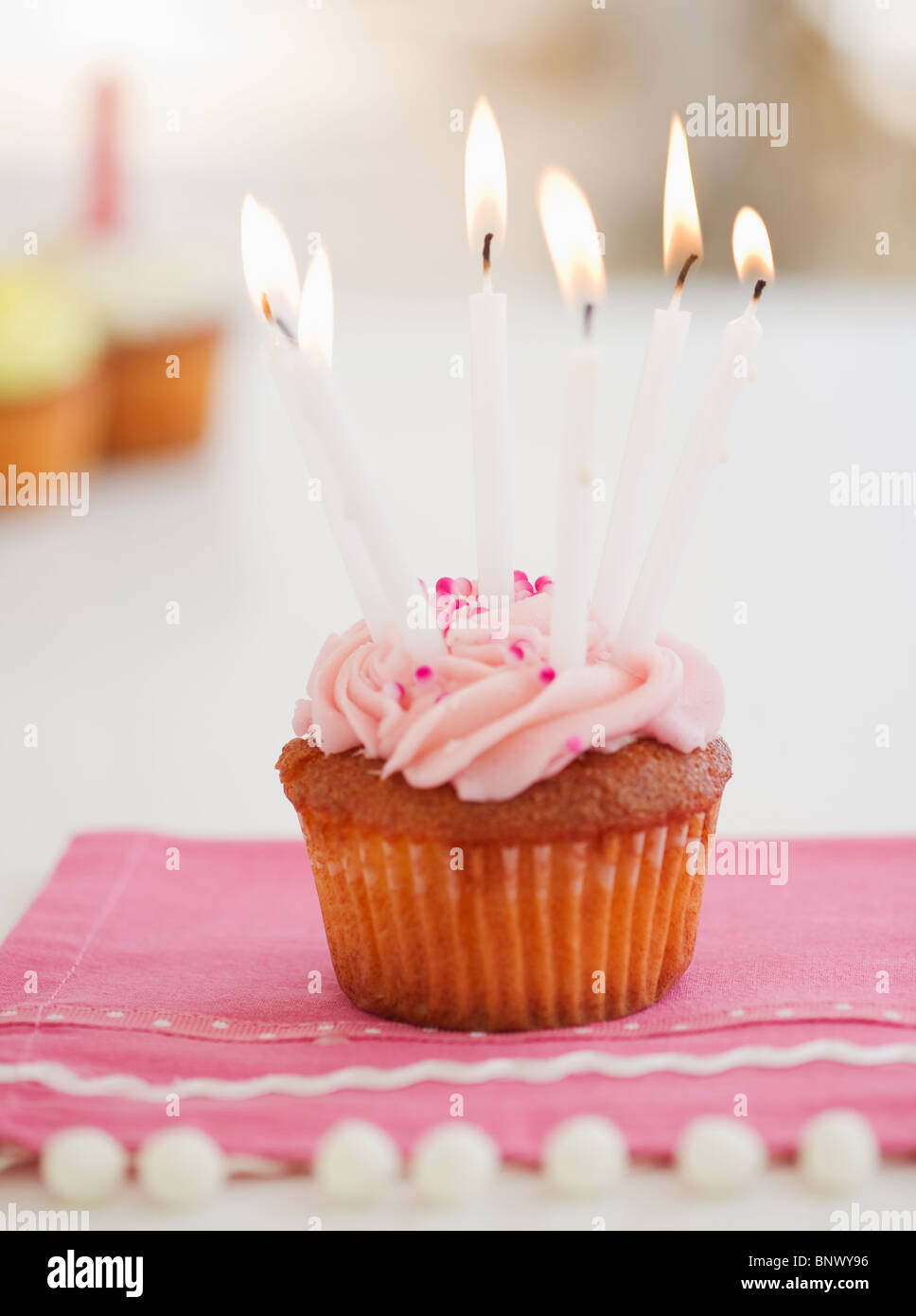 Lit candles on cupcake Stock Photo Alamy