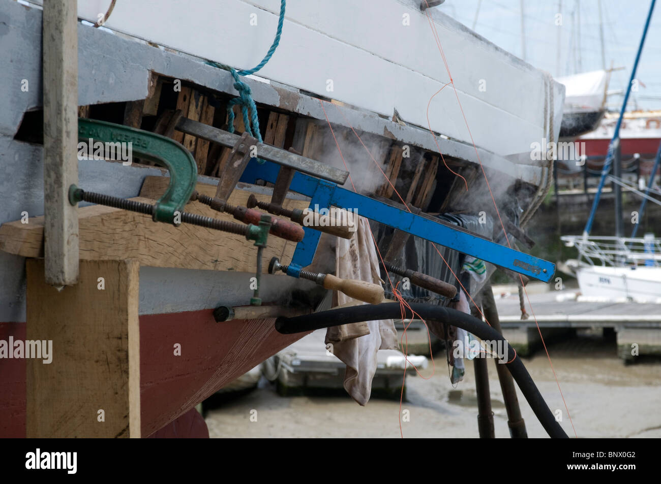 Oyster Yawl the Gamecock built in 1907 under repair having a plank replaced by steaming in a bag to aid in bending the wooden Stock Photo