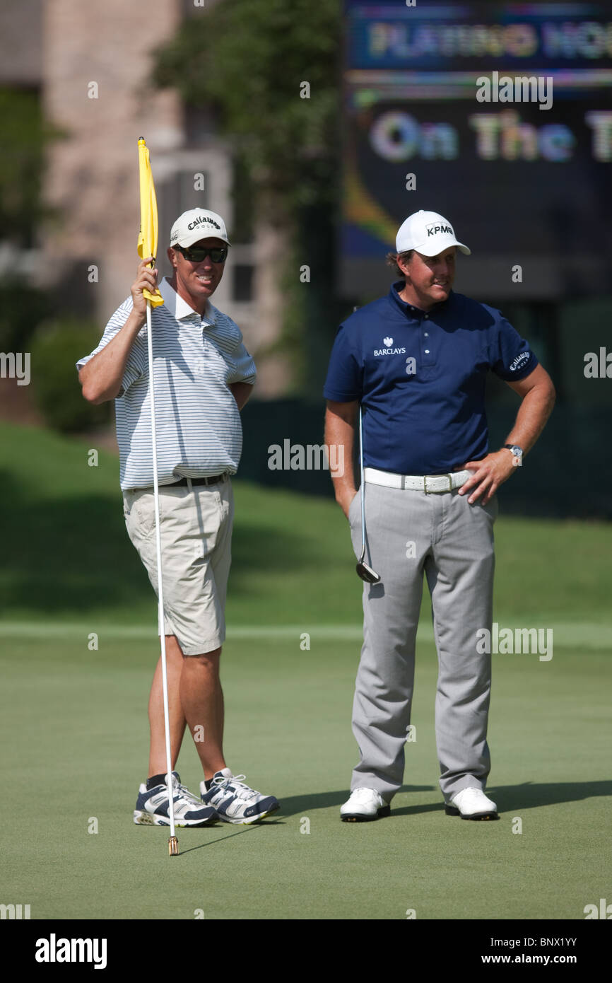 Phil Michelson and caddie Jim "Bones" MacKay talk on the 10th green