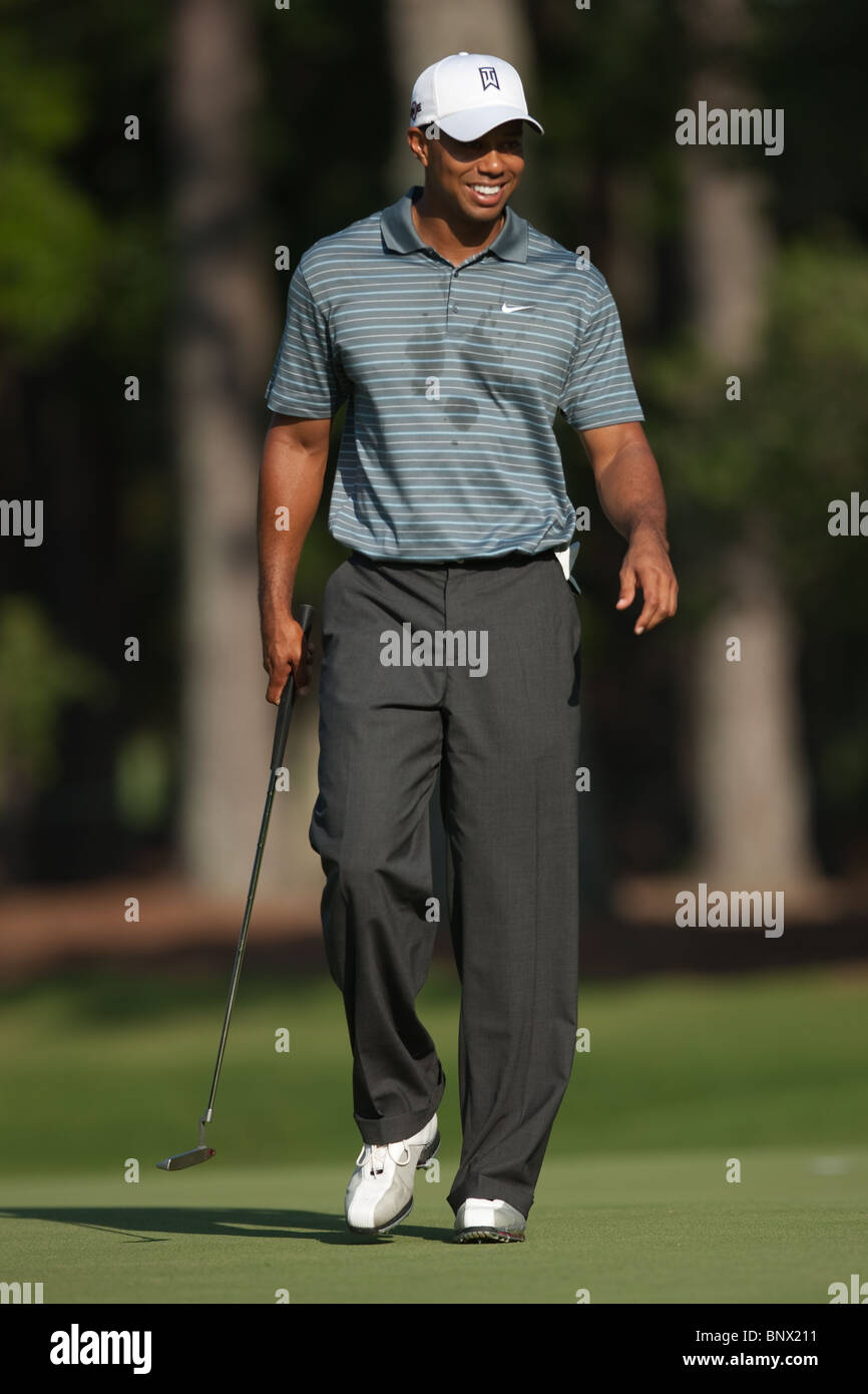 Tiger Woods smiles as he walks on the green of the par 3 8th hole during a practice round of the 2009 Players Championship. Stock Photo