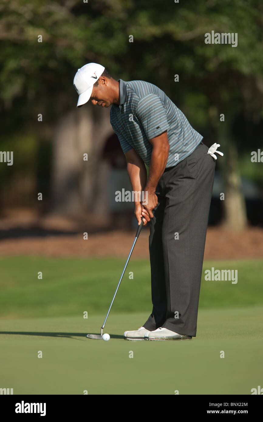 Tiger Woods putts on the green of the par 3 8th hole during a practice round of the 2009 Players Championship. Stock Photo