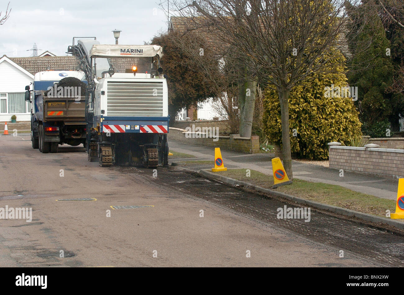 The old surface is taken off a road in preparation before resurfacing UK Stock Photo