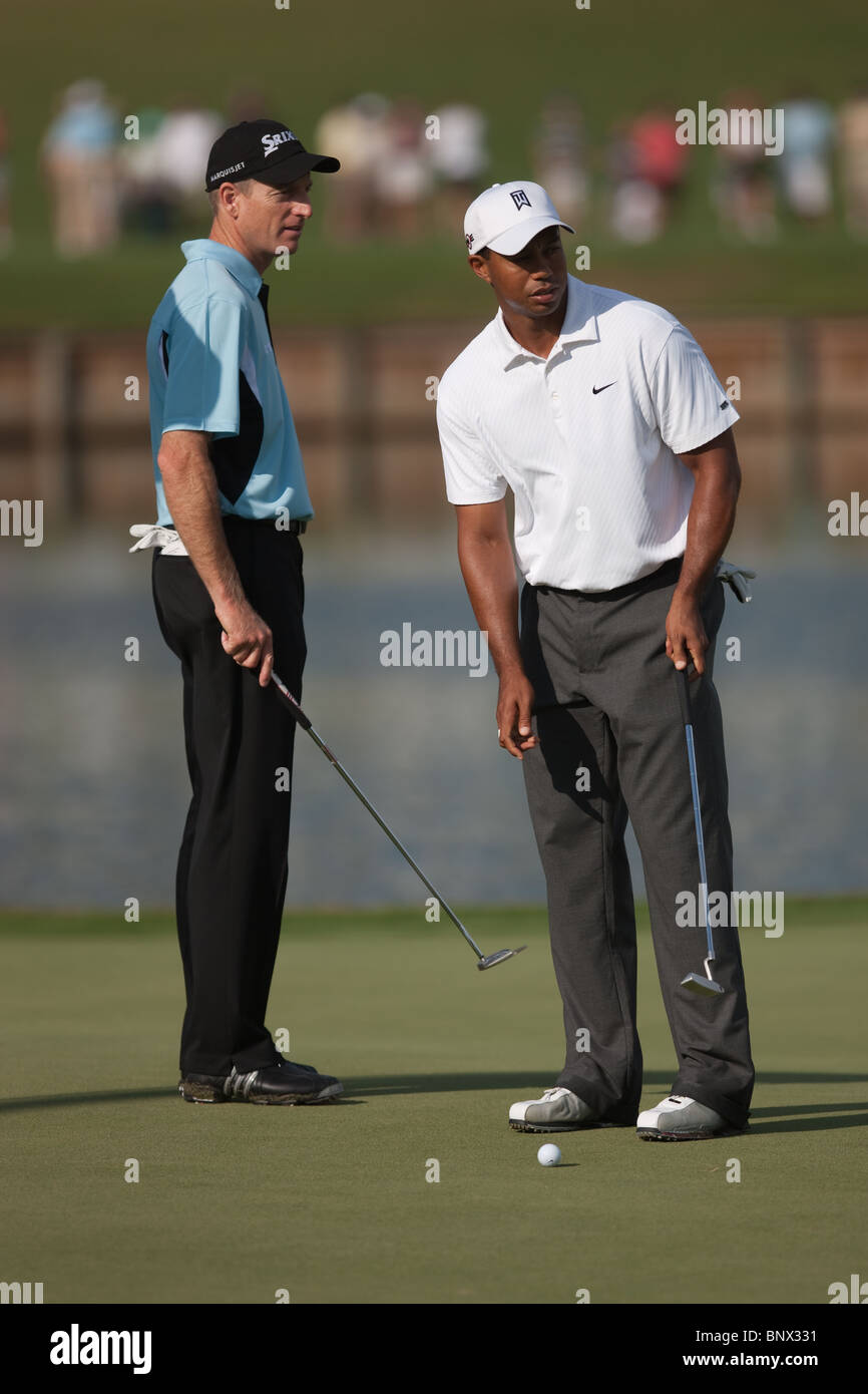 Jim Furyk and Tiger Woods discuss the slope of the 16th green during a practice round of the 2009 Players Championship. Stock Photo