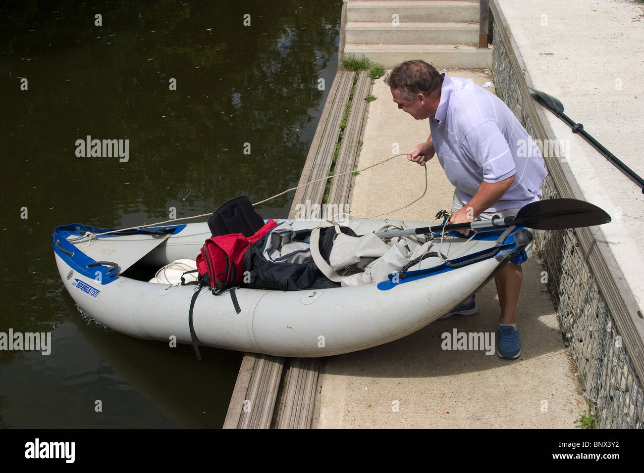 canoe canoeist inflatable portage river launching Stock Photo Alamy