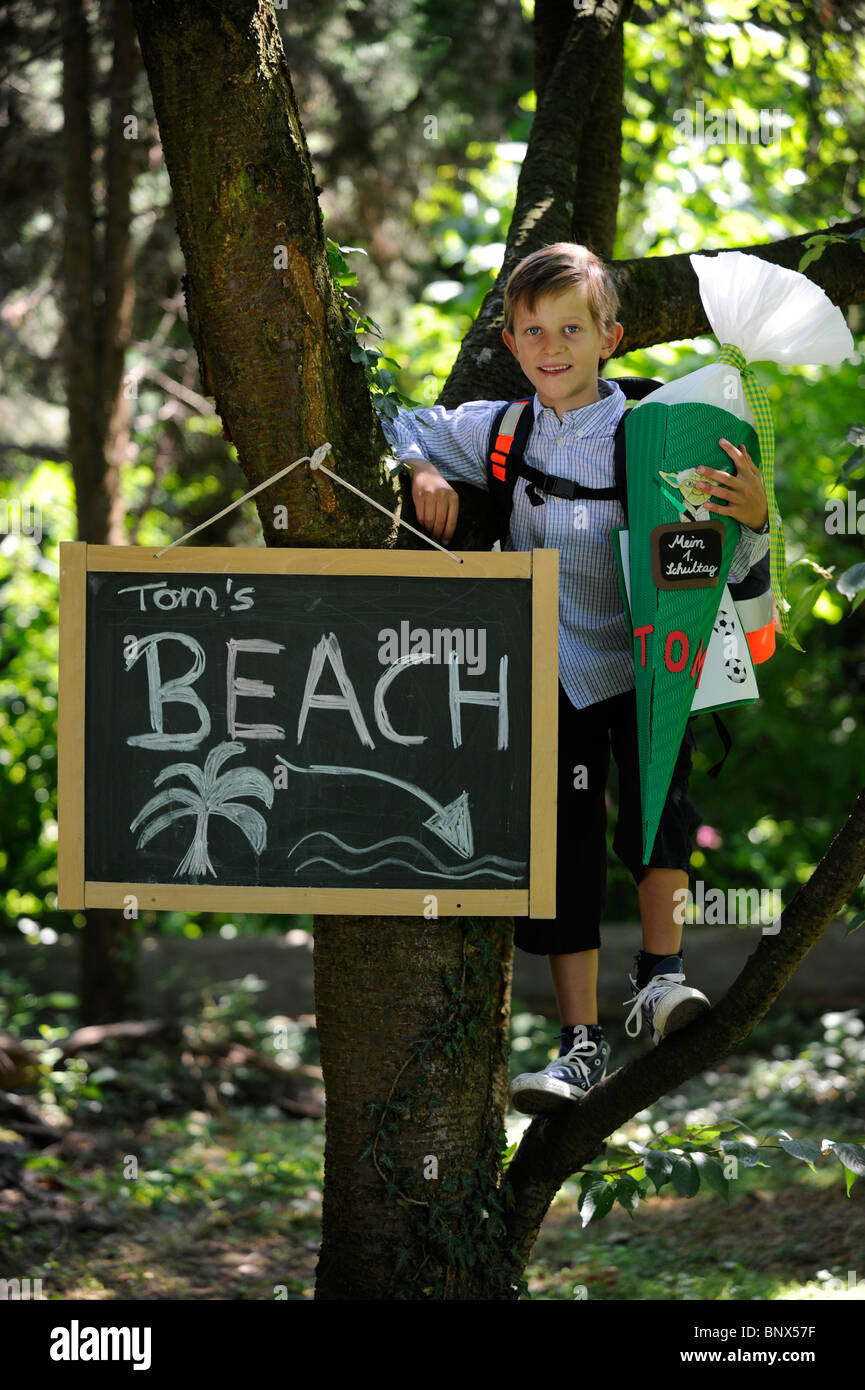 First day at school. Boy with cardboard cone in the schoolyard. Stock Photo