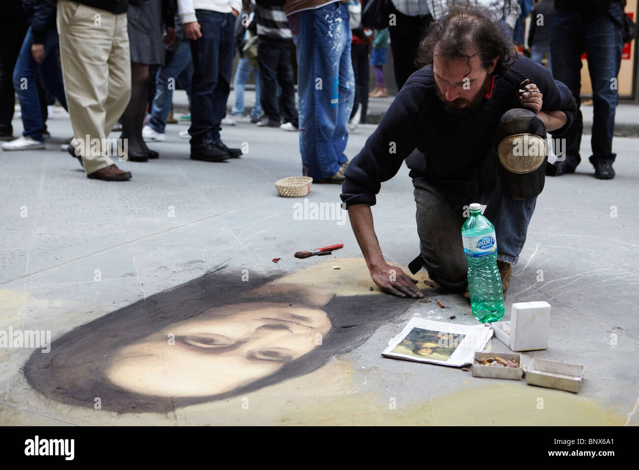 Street artist painting the Mona Lisa on a pavement in Florence, Italy Stock Photo