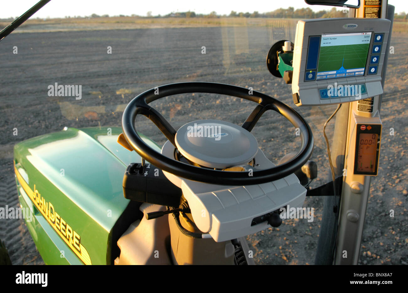 A tractor driver with GPS navigation for accurate field grading Stock