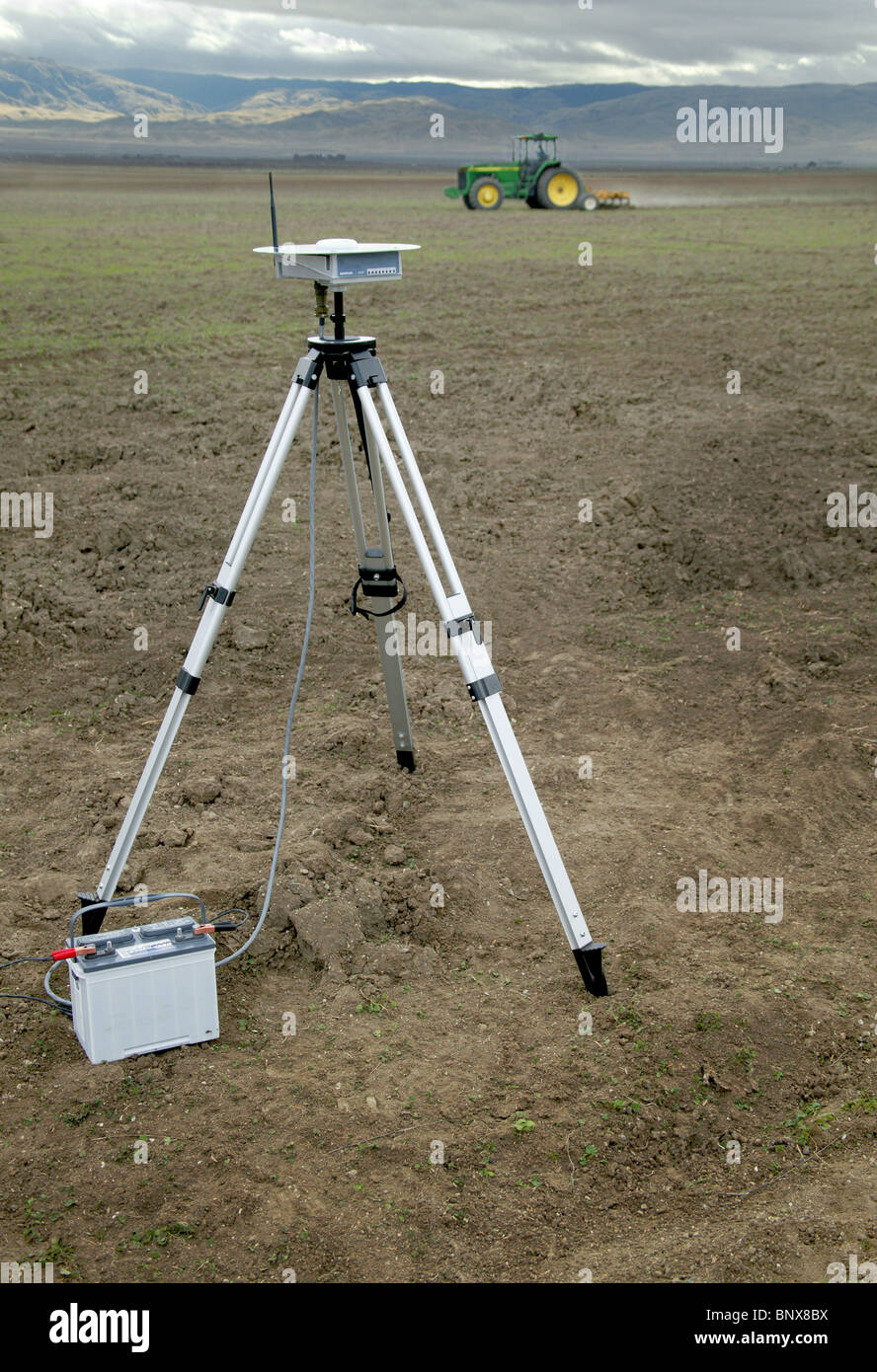 A tractor driver with GPS navigation for accurate field grading Stock