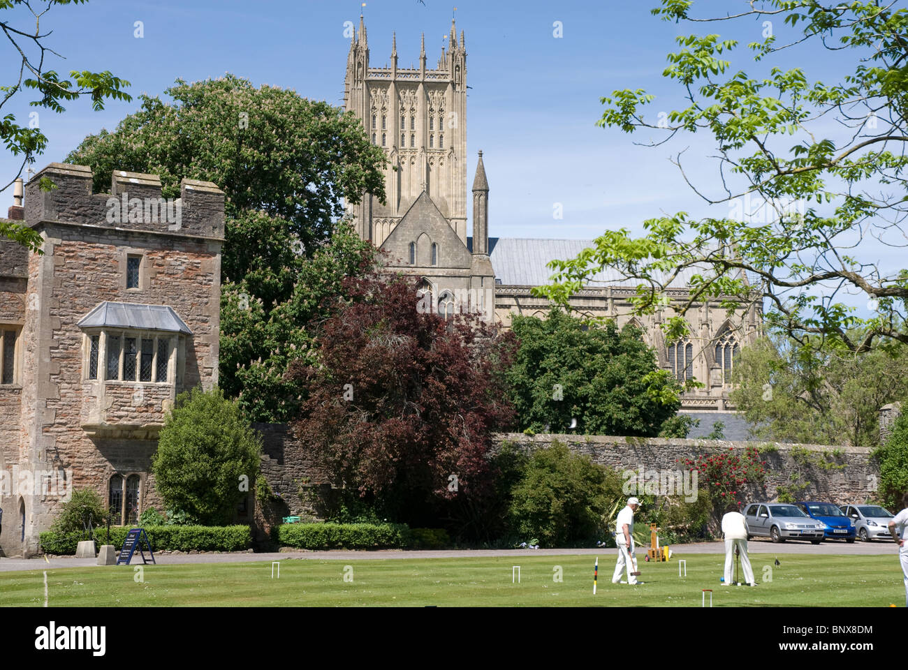Croquet players on the lawn Bishops Palace grounds Wells Somerset, UK Stock Photo