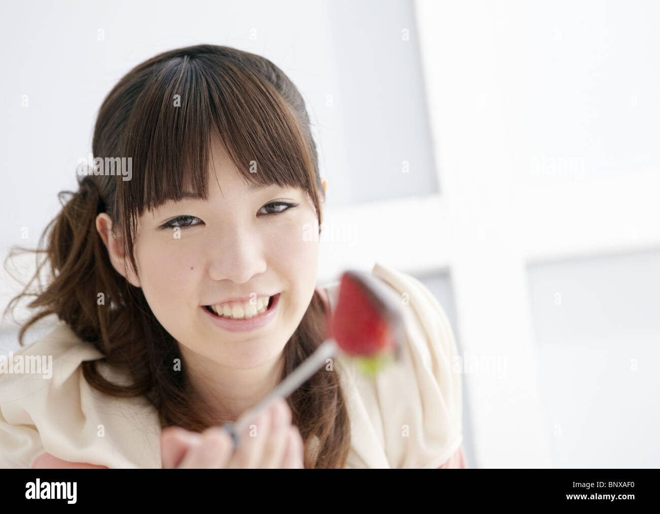 Young woman eating chocolate fondue Stock Photo Alamy