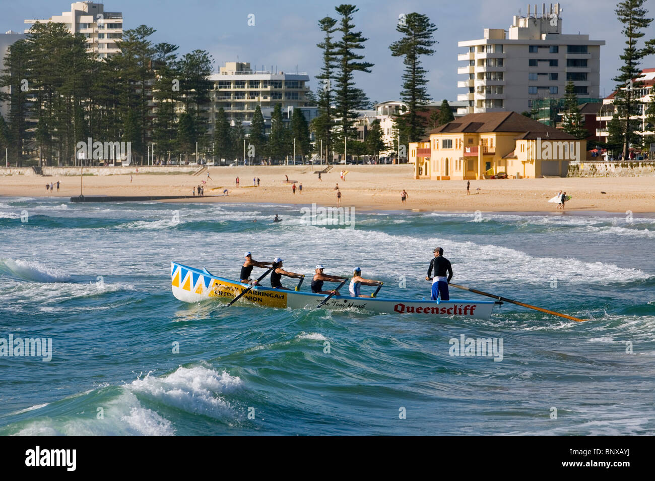 A surfboat team rows into the waves at Manly Beach. Sydney, New South Wales, AUSTRALIA Stock Photo