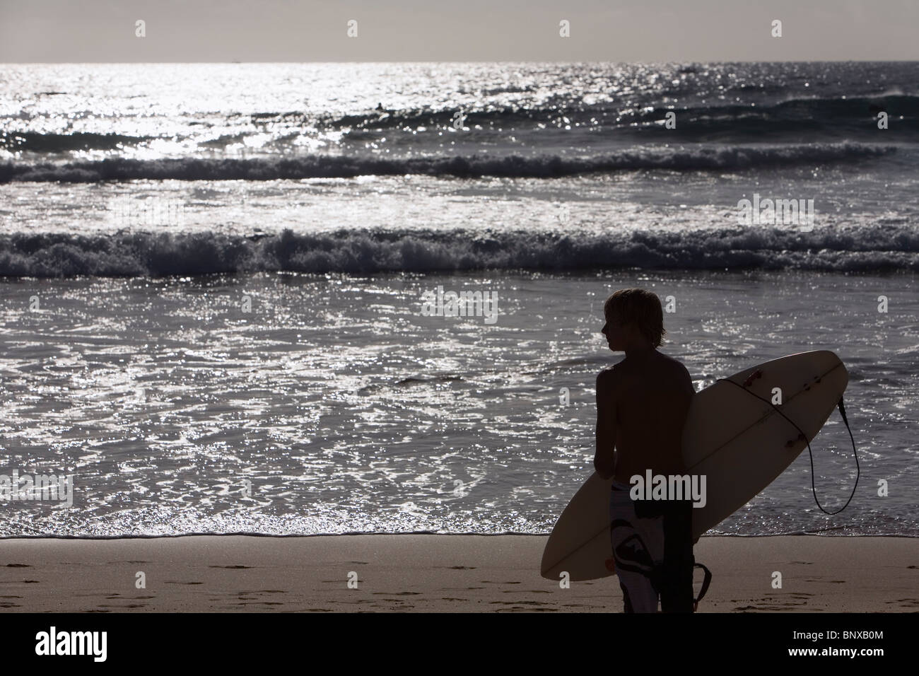 A surfer looks out to the waves at Manly Beach. Sydney, New South Wales, AUSTRALIA Stock Photo