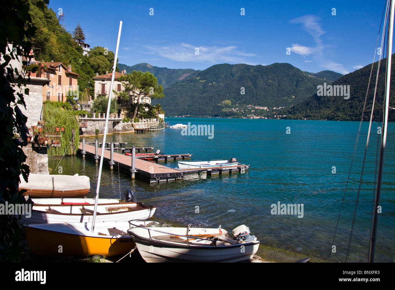 Boats on the shore of Lake Lugano at San Memete Valsolda region on Lake Lugano Italy Stock Photo