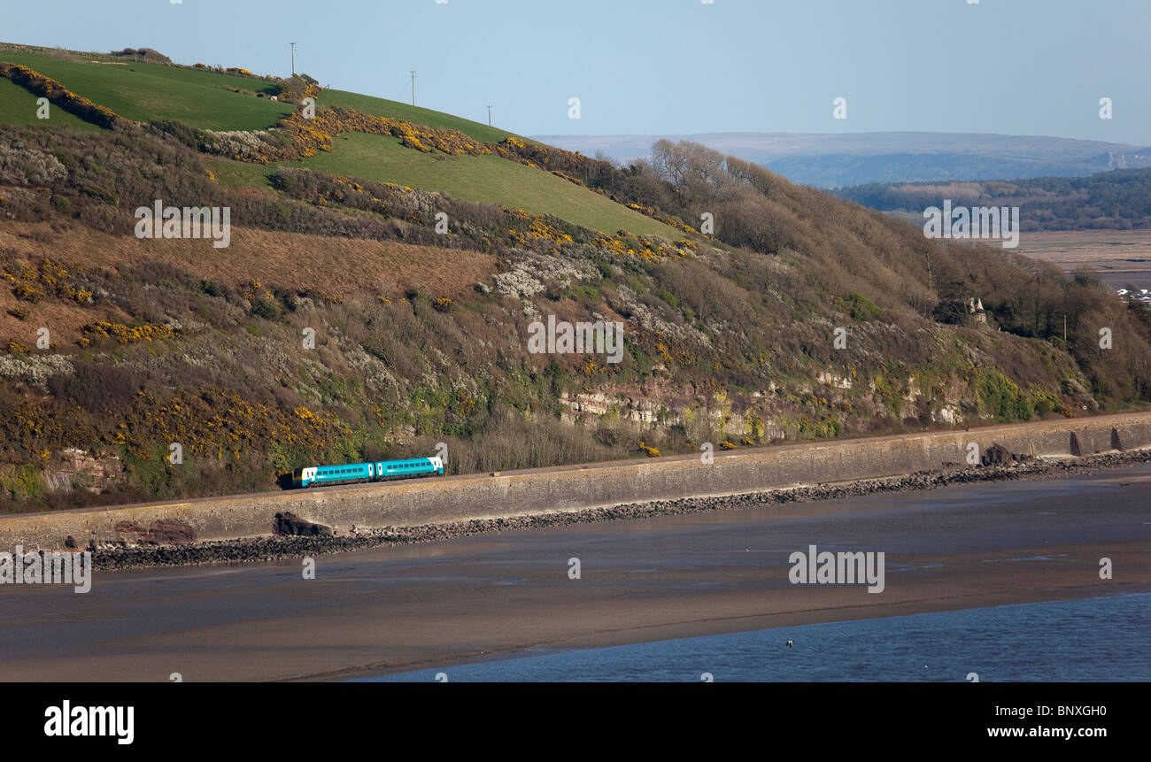 Train on coast railway line at Ferryside on the River Towy estuary Carmarthenshire Wales UK Stock Photo
