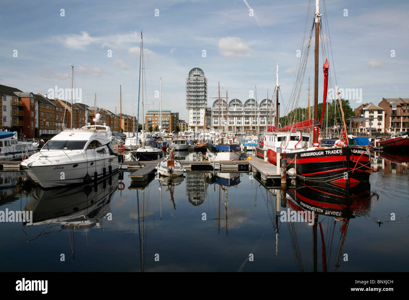 Boats moored in front of Baltic House in the South Dock Marina, Rotherhithe, London, UK Stock Photo