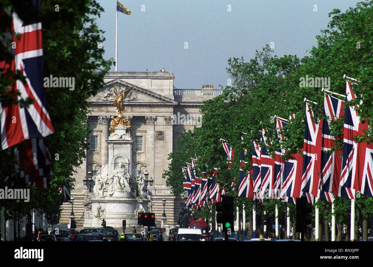 Buckingham Palace,London,England. Union Jack flags fly from gaffs on The Mall leading to the London residence of Her Majesty Qu Stock Photo