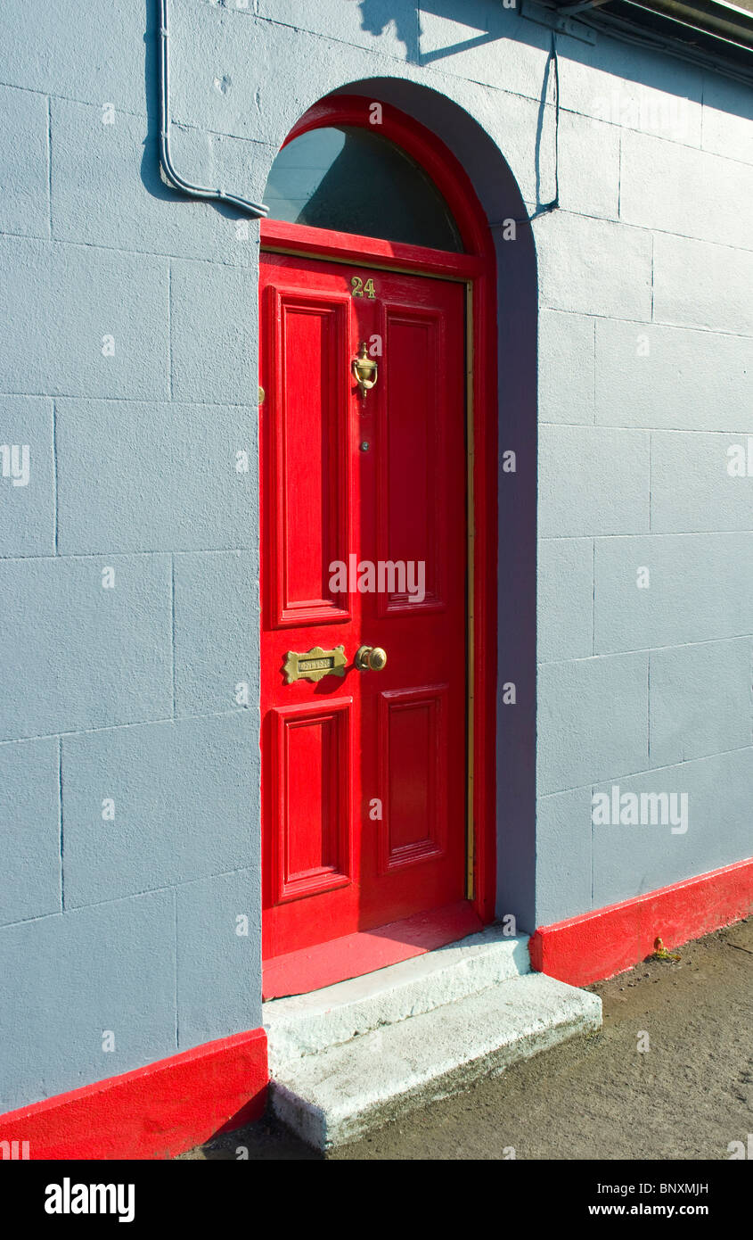 A simple cottage stands out by being personalised by a bright red paint job - Skerries, County Dublin, Ireland Stock Photo