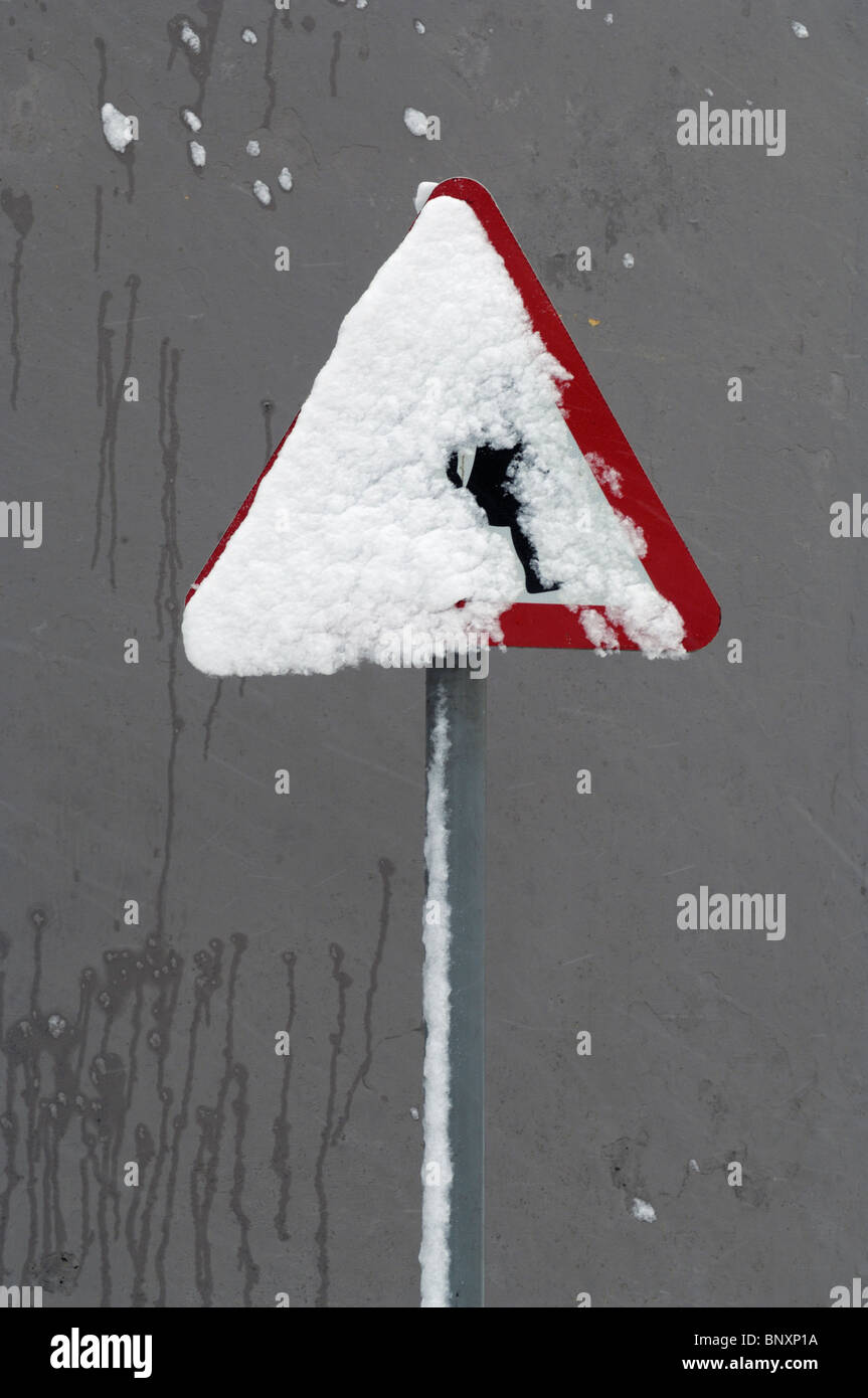 A school crossing sign covered in snow. Wrington, Somerset, England. Stock Photo