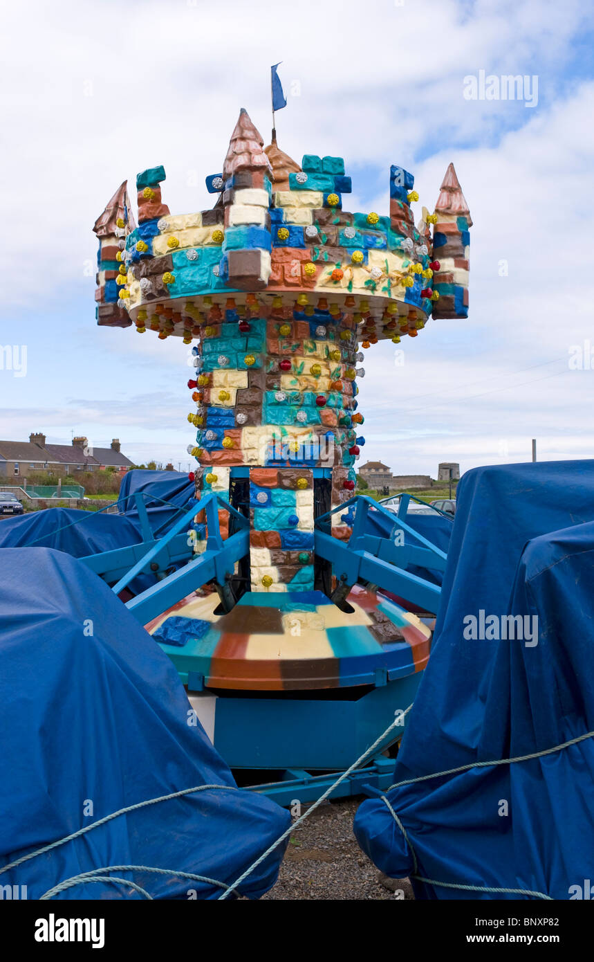 A fairground ride wrapped in blue tarpaulins against the weather at the seaside at Skerries, north county Dublin, Ireland Stock Photo