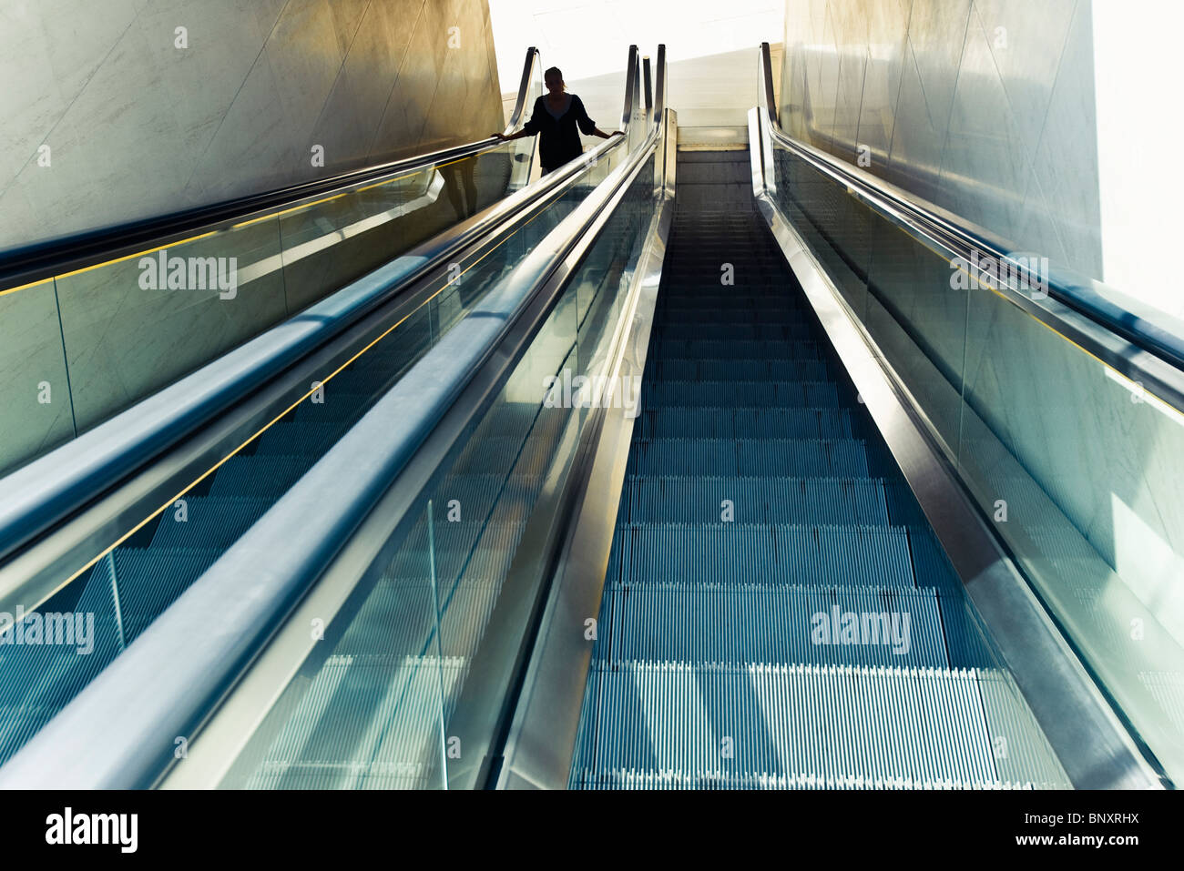 Riding escalator Stock Photo