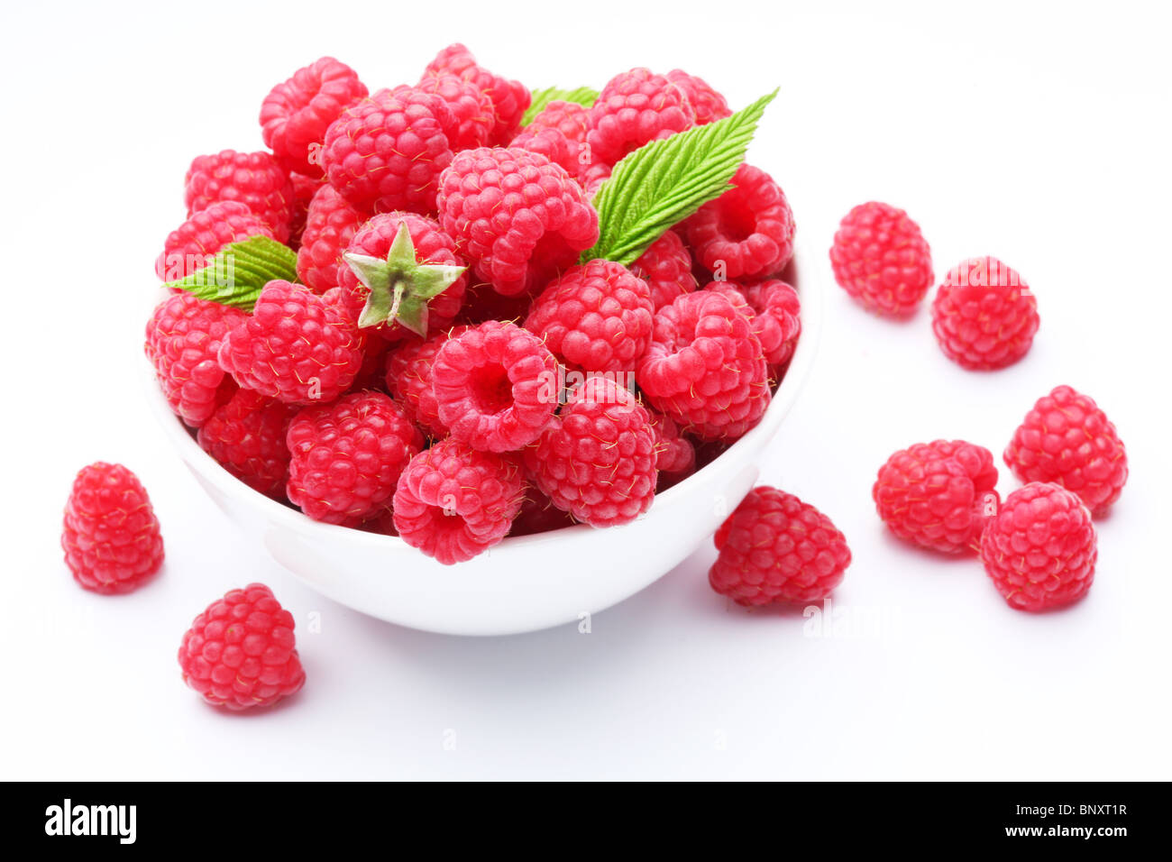 Beautiful Raspberry Crockery with beautiful tempting raspberries. Isolated on white ...
