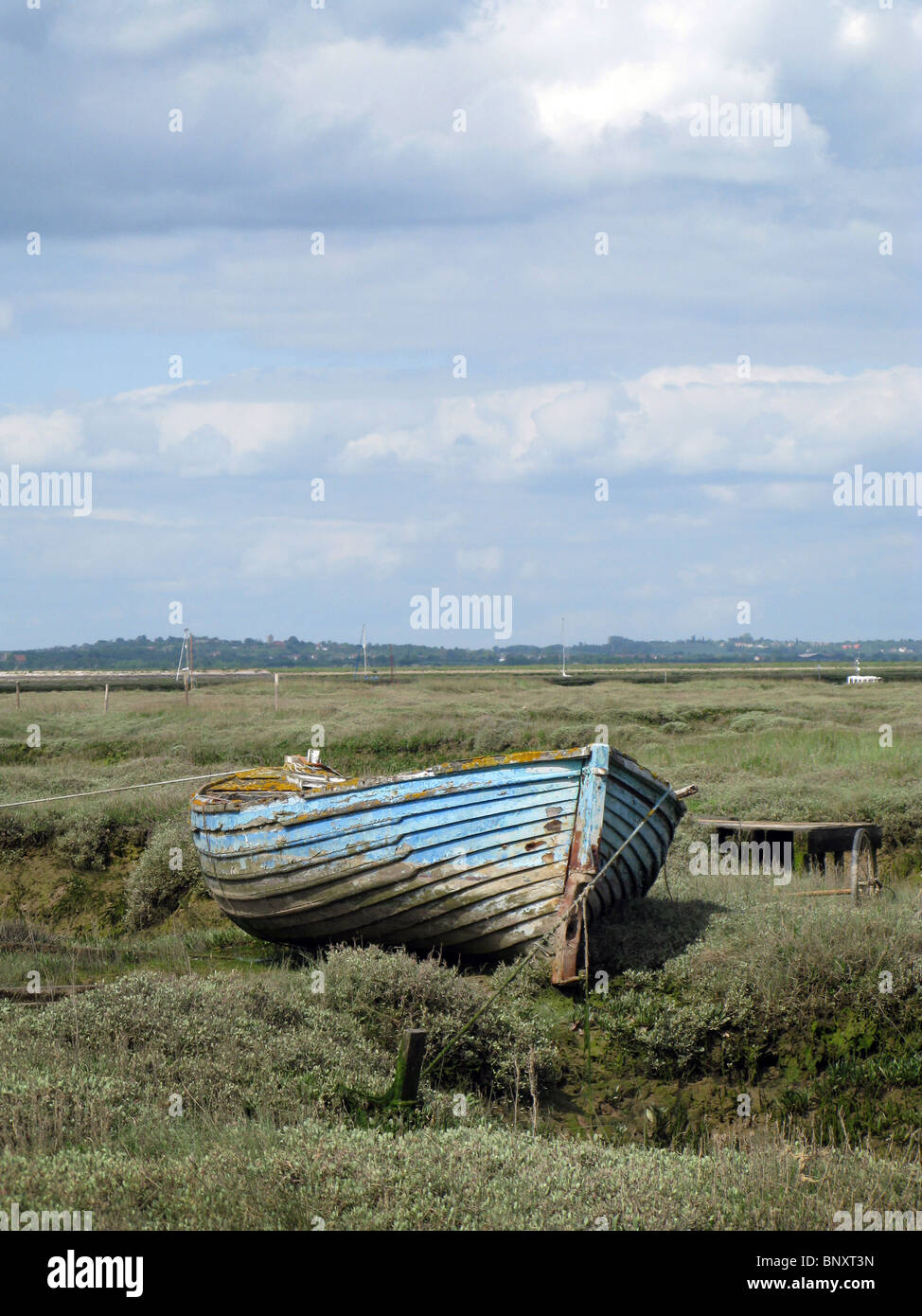 An abandoned wooden boat on the salt marshes at Tollesbury in Essex ...
