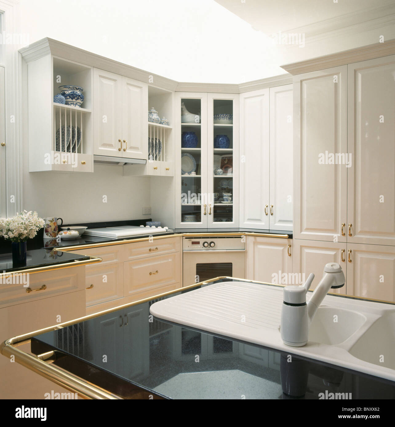 White Corian Sink In Black Granite Worktop In Modern White Kitchen