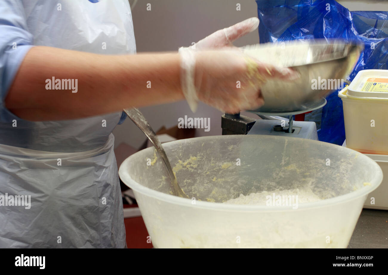 Making scones - adding butter/fat to the mixture Stock Photo