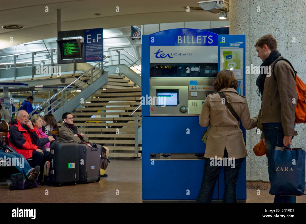 Lyon, France, Couple, inside Train Station, Passengers Buying Tickets, from vending machine Stock Photo