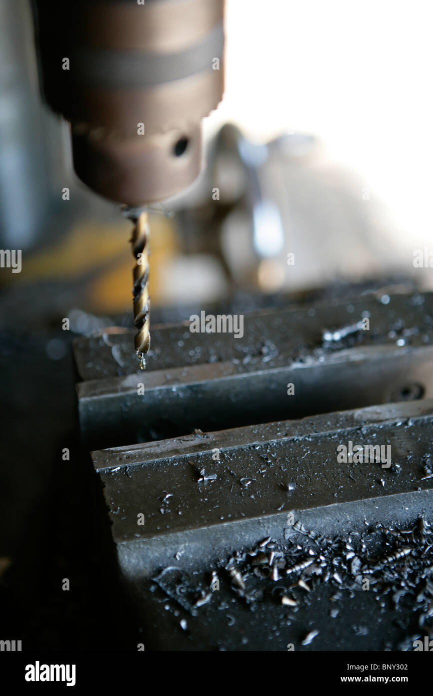 Drill press in motion over vise Stock Photo