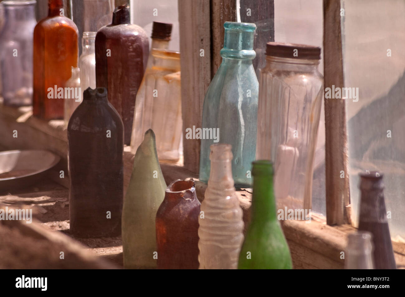 Vintage Glass bottles displayed in store front window at Bodie Hills State Park in California Stock Photo