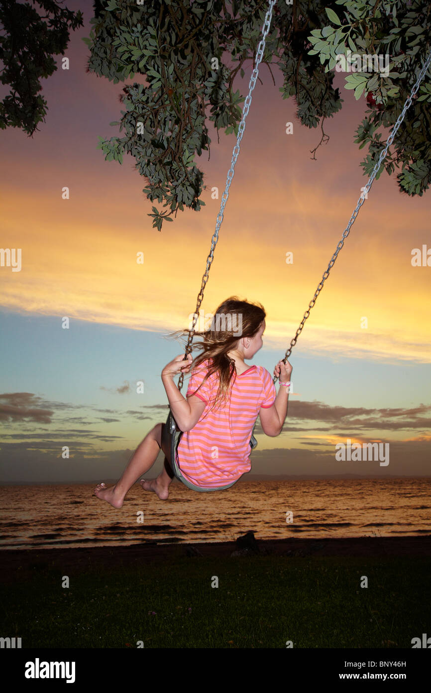 Young Girl on Rope Swing under Pohutukawa Tree at Sunset, Thames