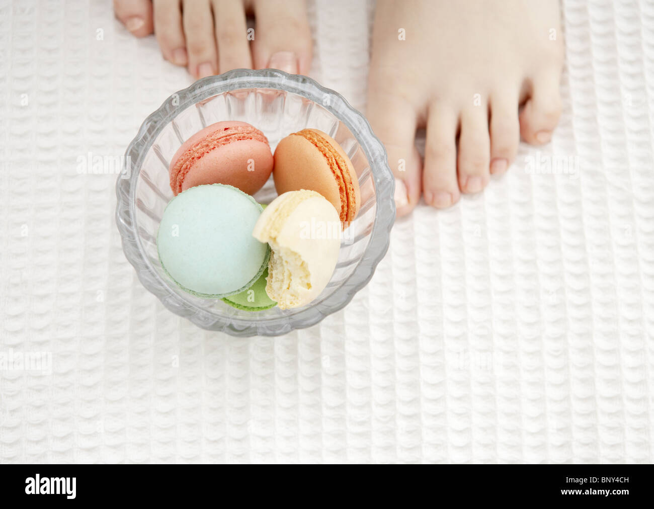 Macaroons and wooman's feet Stock Photo - Alamy