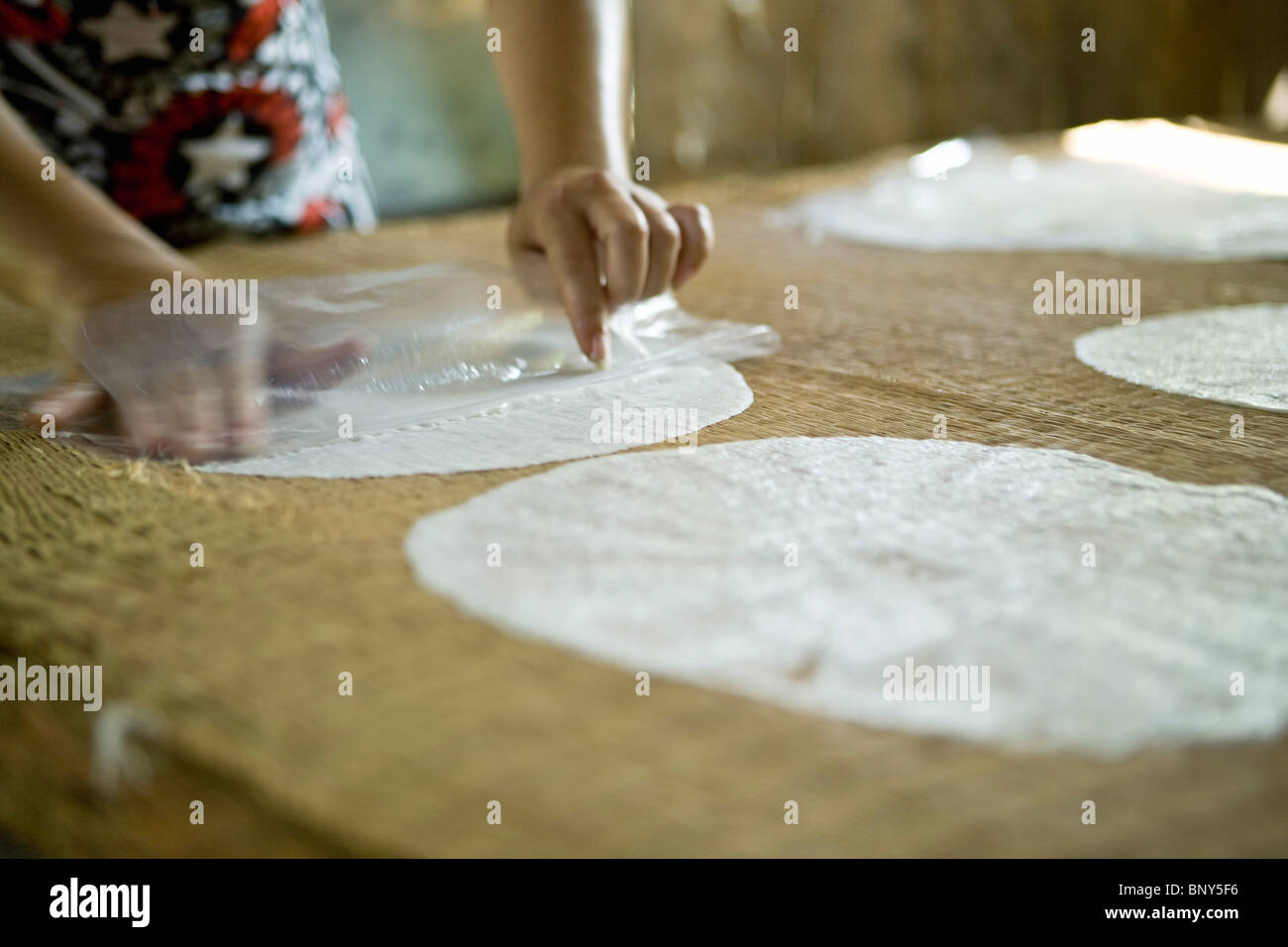 Artisanal production of coconut rice sheets, sheets drying in sun Stock Photo