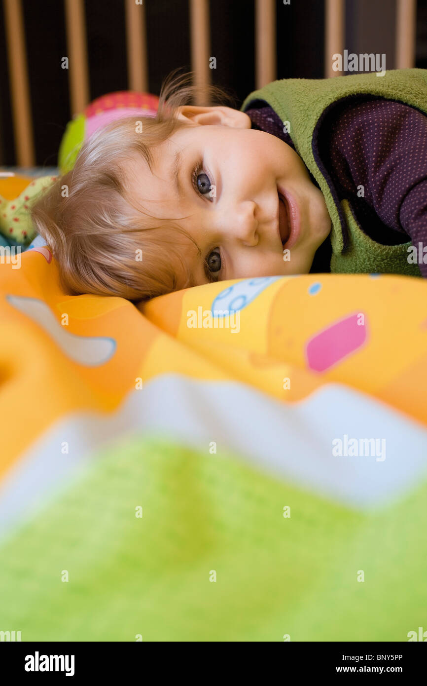 Happy baby girl lying crib hi-res stock photography and images - Alamy