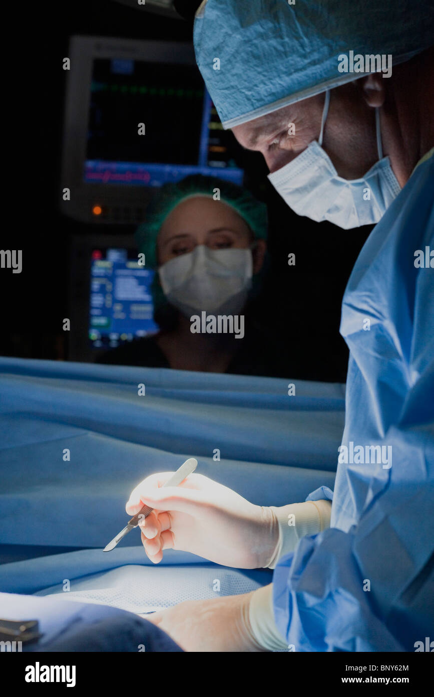Surgeon with scalpel in hand preparing to begin surgery Stock Photo