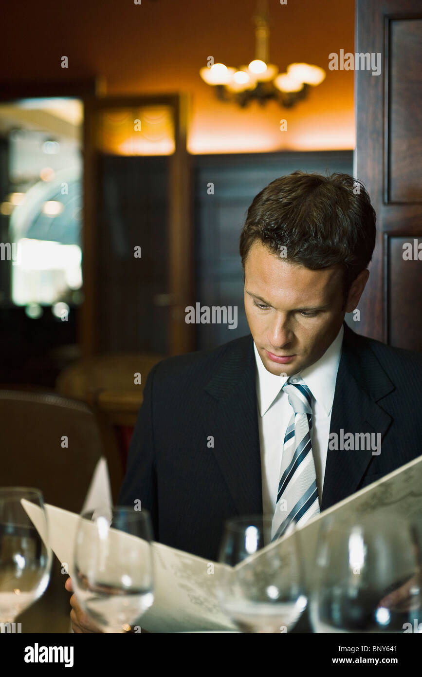Man looking at menu in fine restaurant Stock Photo