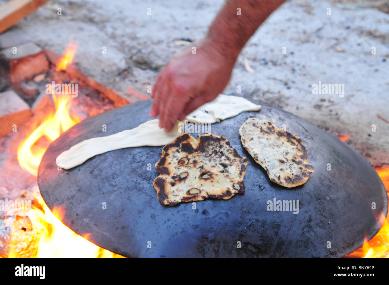 Outdoor Cooking preparing a flat bread Pita on a Saj Stock Photo Alamy