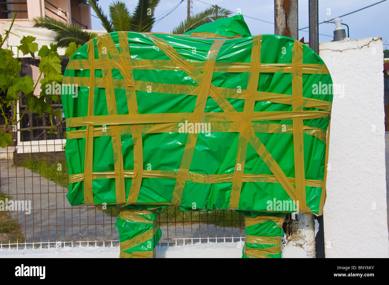 Out of season public telephones taped up covered in green plastic Sidari on the Greek island of Corfu Greece GR Stock Photo