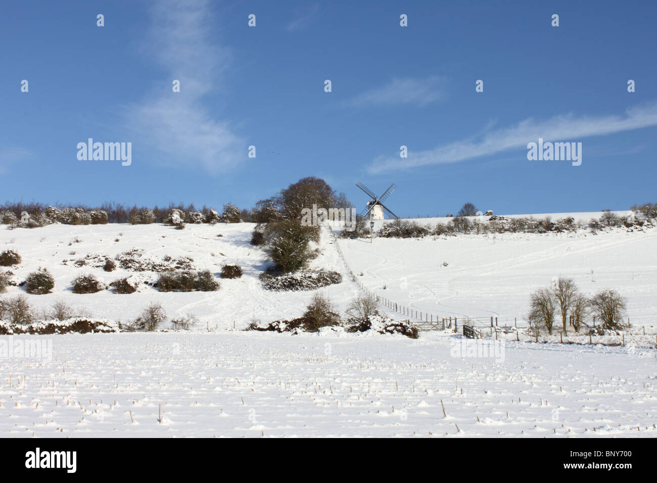 Cobstone Windmill above Turville Village in snow, Chiltern Hills, Buckinghamshire, England, UK, sunshine, blue sky Stock Photo