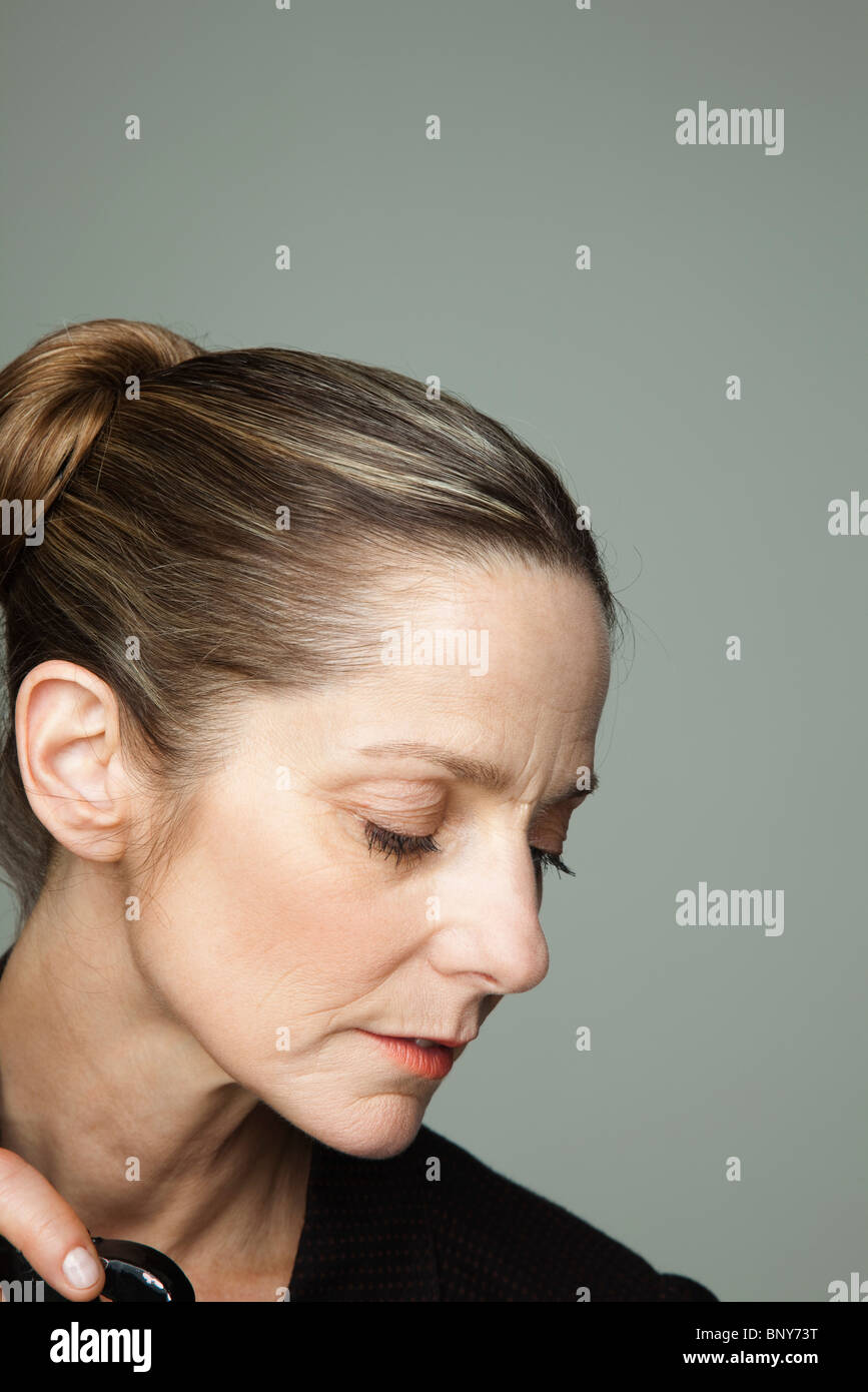 Mature woman looking down, portrait Stock Photo