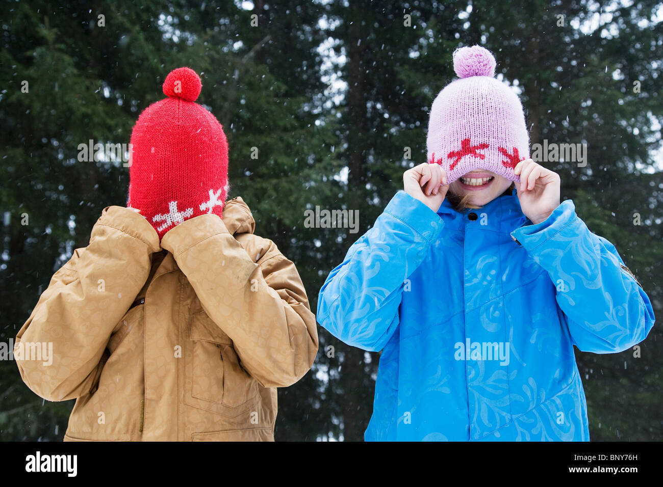 Children playing with wooly hats Stock 